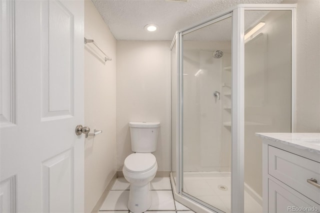 3912 S Richfield Way, Aurora, CO 80013 - bathroom featuring a shower stall, toilet, a textured ceiling, vanity, and tile patterned floors