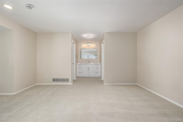3912 S Richfield Way, Aurora, CO 80013 - spare room featuring light carpet, baseboards, and a sink