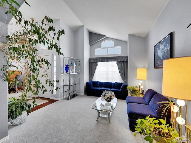 living room featuring carpet and high vaulted ceiling