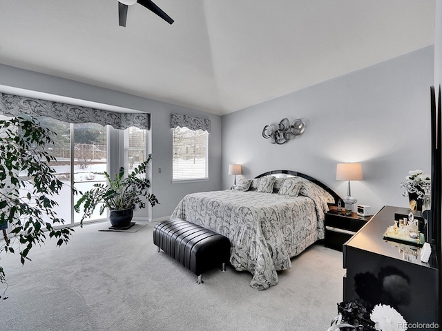 bedroom featuring ceiling fan, lofted ceiling, and light carpet