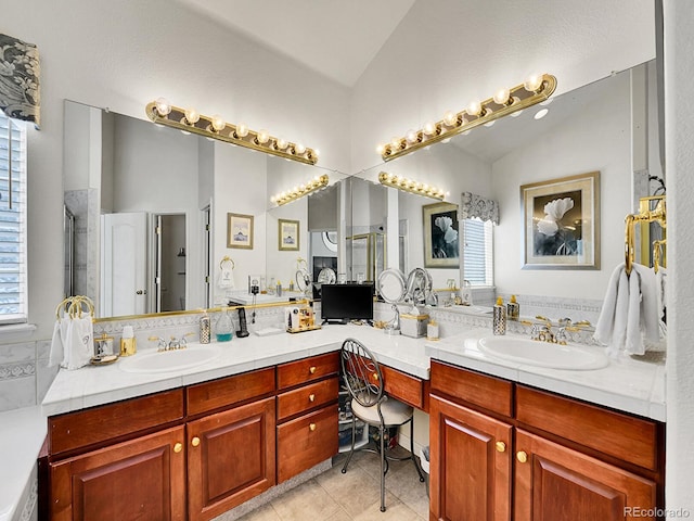 bathroom with tile patterned floors, vanity, an enclosed shower, and vaulted ceiling