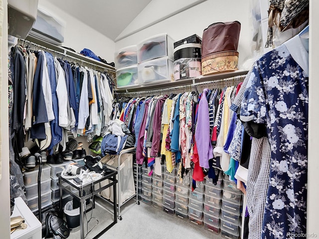 walk in closet with carpet flooring and lofted ceiling