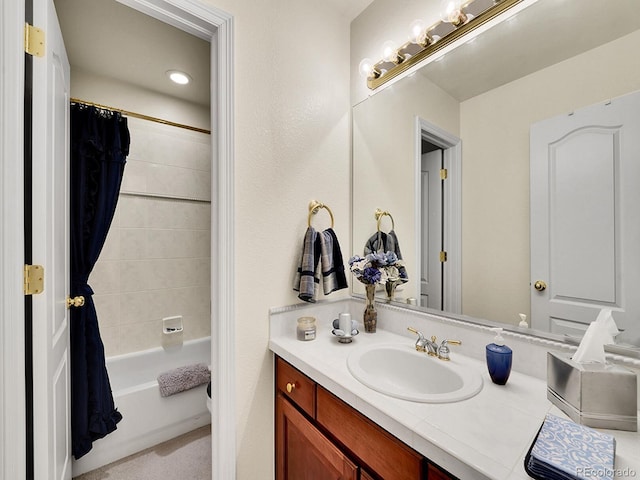 bathroom featuring vanity and shower / bathtub combination with curtain