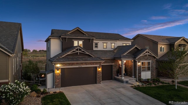 3056 Yale Dr, Broomfield, CO 80023 - view of front facade with driveway, stone siding, and a garage