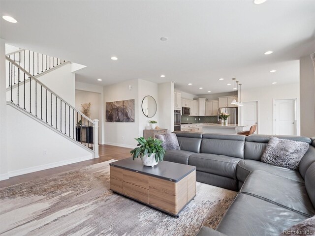 3056 Yale Dr, Broomfield, CO 80023 - living area with wood finished floors, recessed lighting, and stairs