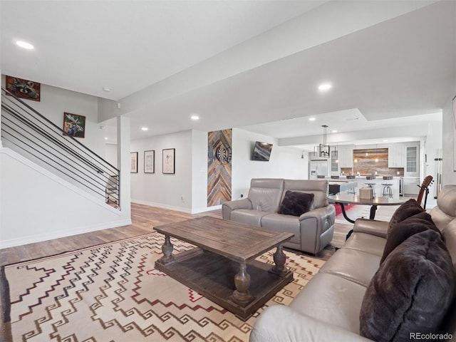3056 Yale Dr, Broomfield, CO 80023 - living room with light wood finished floors, stairs, and recessed lighting