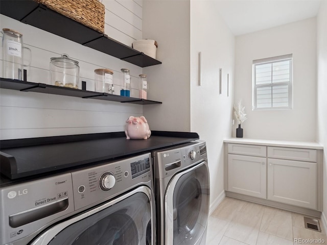 3056 Yale Dr, Broomfield, CO 80023 - laundry area featuring independent washer and dryer, cabinet space, and light marble finish floors