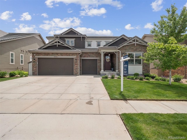 3056 Yale Dr, Broomfield, CO 80023 - craftsman-style house featuring concrete driveway, a front lawn, stone siding, and an attached garage