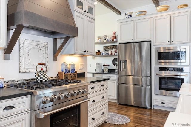 kitchen featuring appliances with stainless steel finishes, beam ceiling, white cabinets, dark hardwood / wood-style flooring, and custom exhaust hood