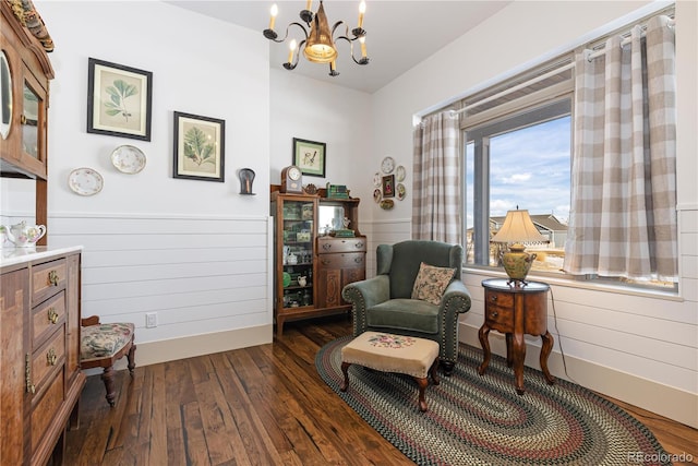 sitting room with dark hardwood / wood-style floors and a notable chandelier