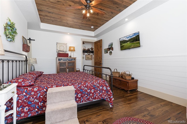 bedroom featuring dark hardwood / wood-style flooring, wood ceiling, and a raised ceiling