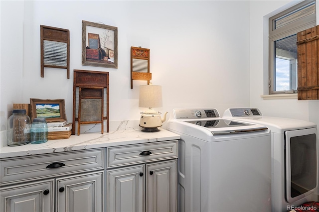 laundry area with cabinets and separate washer and dryer