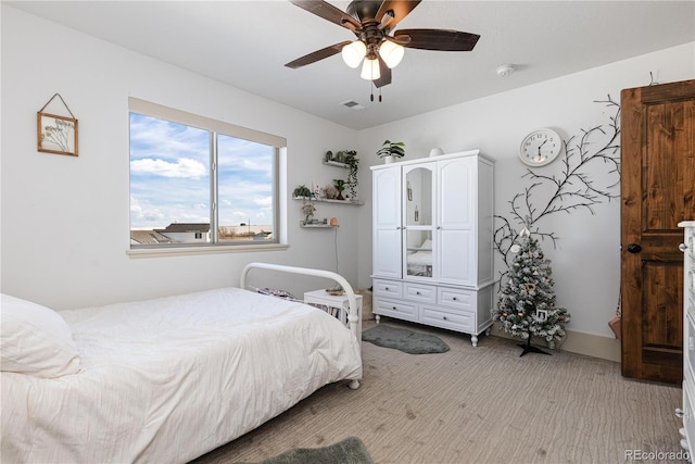 bedroom with light colored carpet and ceiling fan