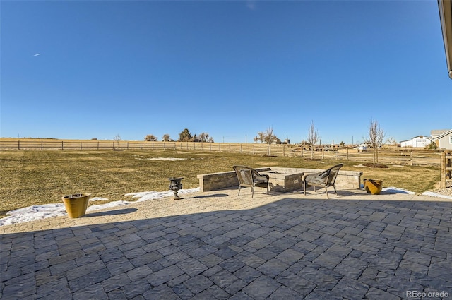 view of patio featuring a rural view and a fire pit