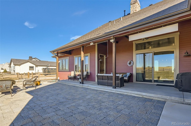 rear view of house featuring outdoor lounge area and a patio