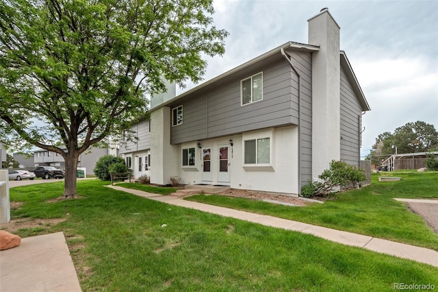 1275 Soaring Eagle Dr, Colorado Springs, CO 80915 - view of front of house with a chimney and a front lawn