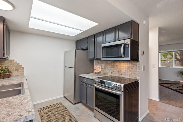 1275 Soaring Eagle Dr, Colorado Springs, CO 80915 - kitchen with stainless steel appliances, tasteful backsplash, and light countertops