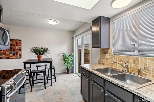 1275 Soaring Eagle Dr, Colorado Springs, CO 80915 - kitchen featuring appliances with stainless steel finishes, decorative backsplash, and light countertops