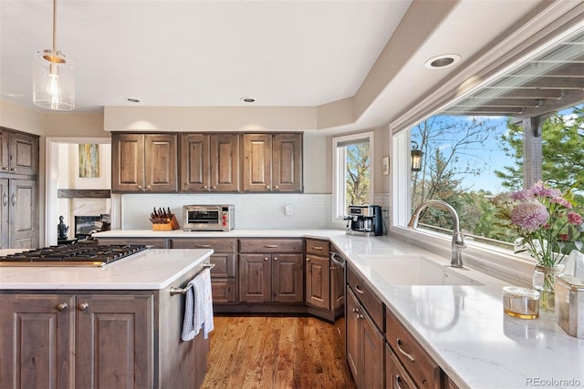150 Chantrey Ct, Colorado Springs, CO 80906 - kitchen featuring light stone counters, a sink, backsplash, and stainless steel appliances