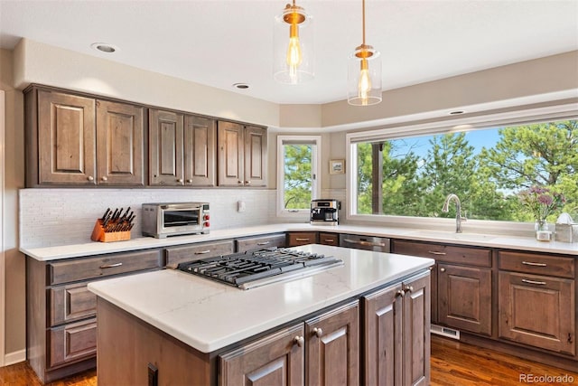 150 Chantrey Ct, Colorado Springs, CO 80906 - kitchen with dark wood-style flooring, stainless steel appliances, a sink, and a center island