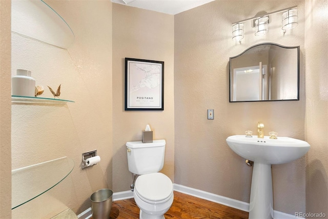 150 Chantrey Ct, Colorado Springs, CO 80906 - half bath with baseboards, wood finished floors, and toilet