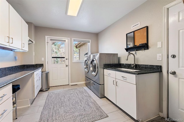 150 Chantrey Ct, Colorado Springs, CO 80906 - laundry area featuring a sink, light tile patterned floors, washing machine and dryer, and cabinet space