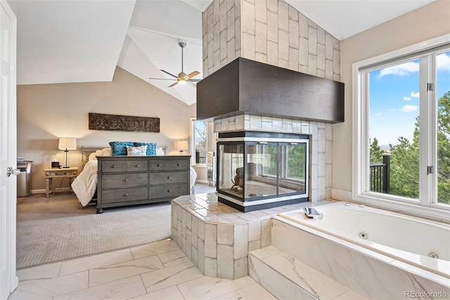 150 Chantrey Ct, Colorado Springs, CO 80906 - full bathroom featuring ceiling fan, marble finish floor, a jetted tub, a multi sided fireplace, and lofted ceiling