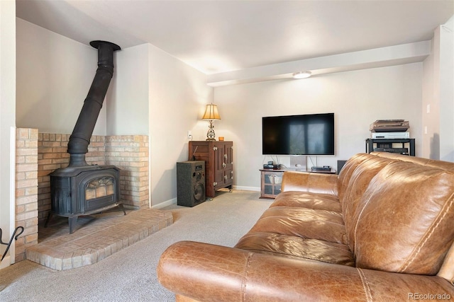 150 Chantrey Ct, Colorado Springs, CO 80906 - living room featuring baseboards, a wood stove, and carpet flooring
