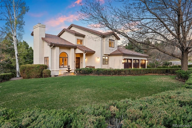 150 Chantrey Ct, Colorado Springs, CO 80906 - view of front of house with a chimney, a yard, stucco siding, and a tiled roof