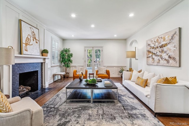 living room with dark hardwood / wood-style floors, crown molding, and french doors