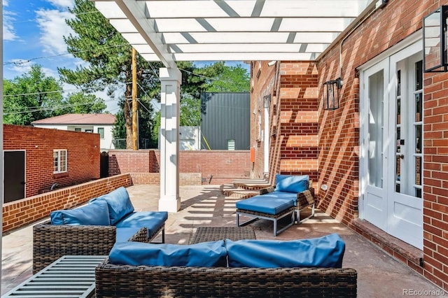 view of patio featuring outdoor lounge area, a pergola, and french doors