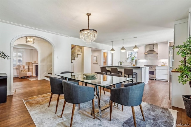 dining area with dark hardwood / wood-style floors and an inviting chandelier