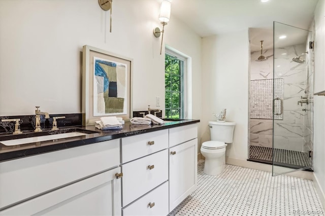 bathroom featuring vanity, toilet, and a shower with door