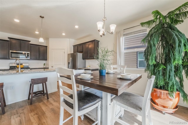 dining room with a chandelier and light hardwood / wood-style floors