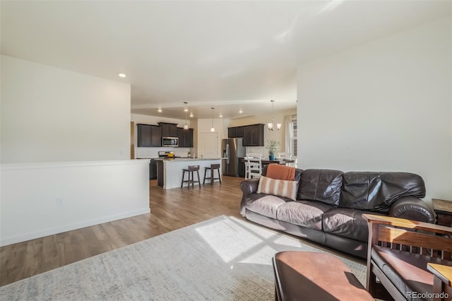 living room featuring hardwood / wood-style flooring and a notable chandelier