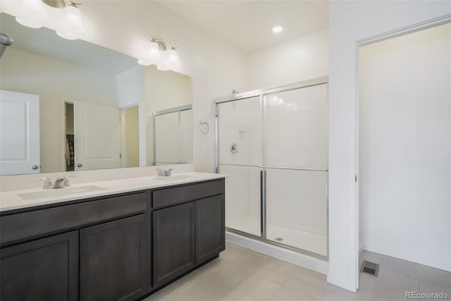 bathroom with vanity and a shower with shower door