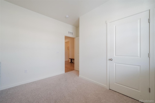 unfurnished bedroom featuring light colored carpet