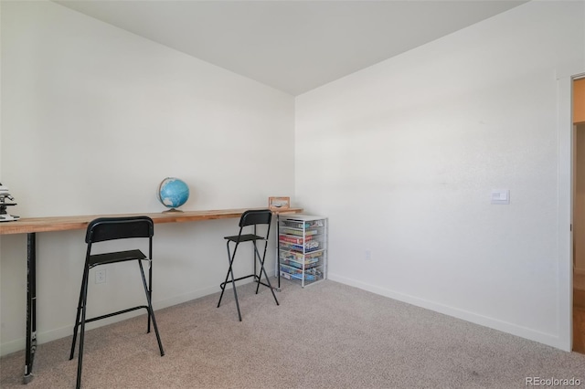 office space featuring light carpet and built in desk