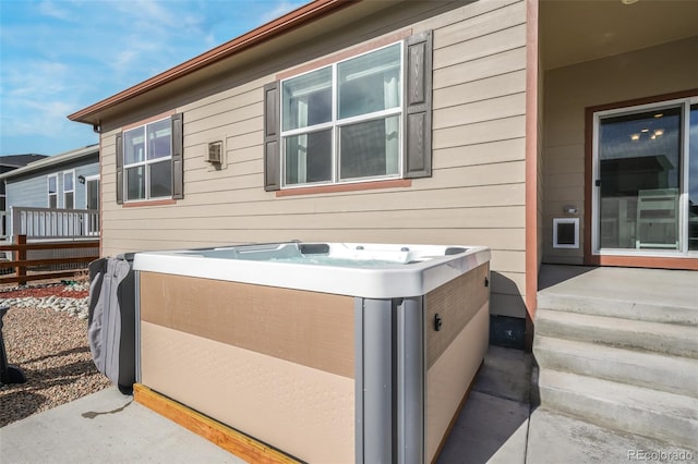 view of side of property with a hot tub