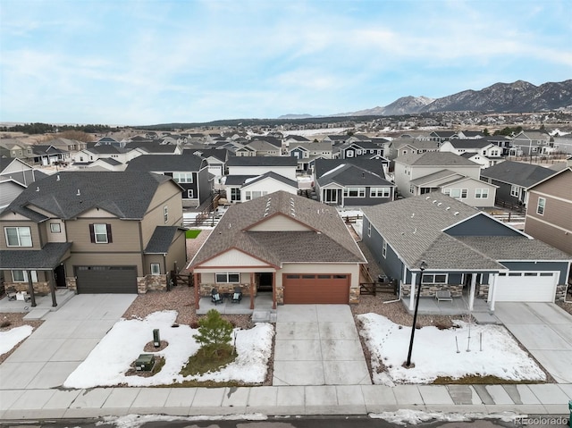 snowy aerial view featuring a mountain view