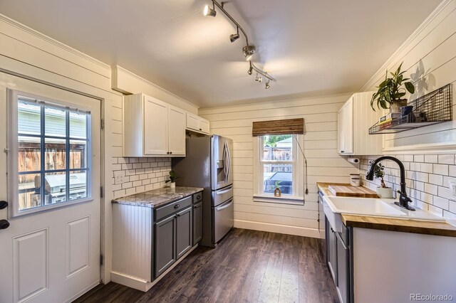 235 W Lehigh Ave, Englewood, CO 80110 - kitchen with stainless steel fridge with ice dispenser, healthy amount of natural light, backsplash, and dark wood-style flooring