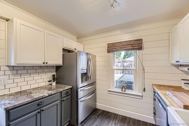 235 W Lehigh Ave, Englewood, CO 80110 - kitchen with stainless steel fridge, dark wood finished floors, white cabinets, wood counters, and wooden walls