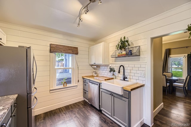 235 W Lehigh Ave, Englewood, CO 80110 - kitchen with appliances with stainless steel finishes, wooden counters, plenty of natural light, dark wood-style floors, and crown molding