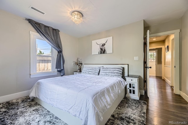 235 W Lehigh Ave, Englewood, CO 80110 - bedroom featuring wood finished floors and a chandelier