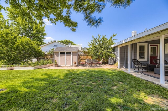 235 W Lehigh Ave, Englewood, CO 80110 - fenced backyard featuring a garden, a storage shed, and a patio