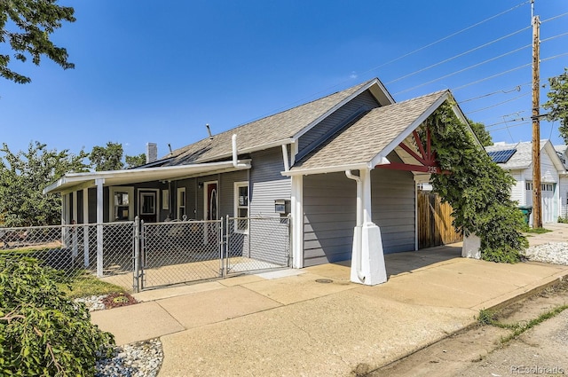 235 W Lehigh Ave, Englewood, CO 80110 - view of front of property with a gate, roof with shingles, an attached carport, and driveway