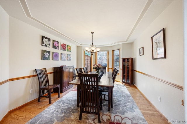 50 Deerwood Dr, Littleton, CO 80127 - dining room with a chandelier, light wood-style floors, and baseboards