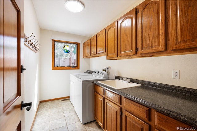 50 Deerwood Dr, Littleton, CO 80127 - washroom featuring washing machine and dryer, cabinet space, baseboards, and light tile patterned flooring
