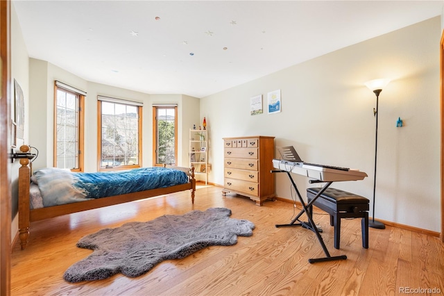 50 Deerwood Dr, Littleton, CO 80127 - bedroom with light wood finished floors and baseboards