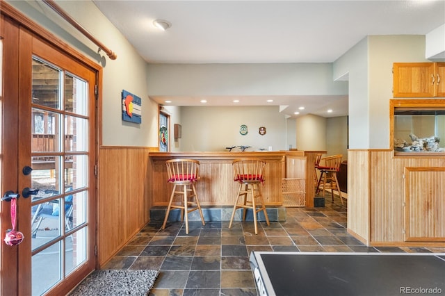 50 Deerwood Dr, Littleton, CO 80127 - indoor dry bar featuring a wainscoted wall, wooden walls, healthy amount of natural light, and dark stone finish floors